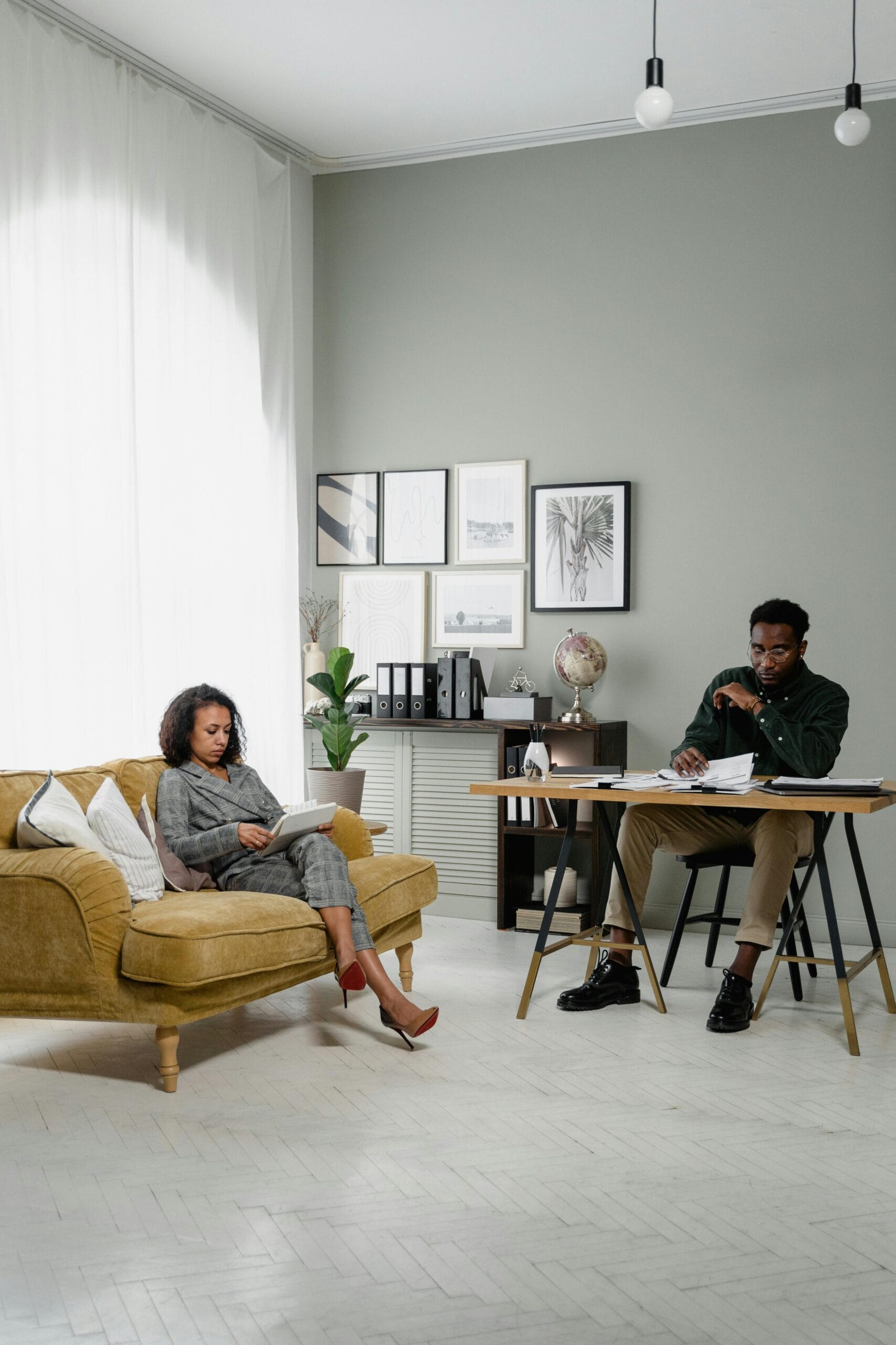 Elegant modern office space with a man and woman working together indoors, emphasizing finance and collaboration.